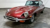 Front view of a 1970 Jaguar E-Type 4.2 (2+2) with a new metallic maroon paint job