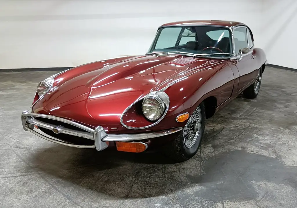 Front view of a 1970 Jaguar E-Type 4.2 (2+2) with a new metallic maroon paint job