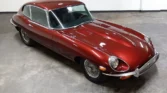 Front view of a 1970 Jaguar E-Type 4.2 (2+2) with a new metallic maroon paint job