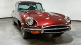 Front view of a 1970 Jaguar E-Type 4.2 (2+2) with a new metallic maroon paint job