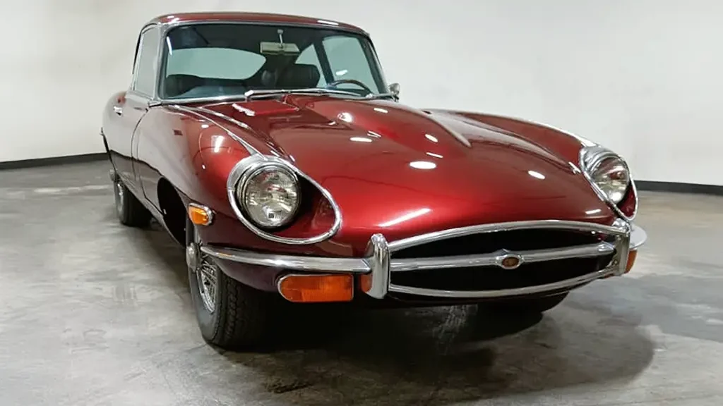 Auto Mart Motors Front view of a 1970 Jaguar E Type 42 2+2 with a new metallic maroon paint job