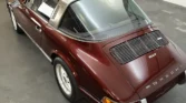 Side view of a 1972 Porsche 911 Targa showcasing its semi-convertible Targa body style and sleek design