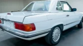 Rear view of the 1988 Mercedes Benz 560SL for sale highlighting its convertible design. Auto Mart Motors