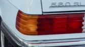 Rear view of the 1988 Mercedes Benz 560SL for sale highlighting its convertible design. Auto Mart Motors