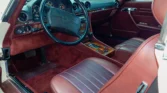 Luxurious medium red leather interior of a 1988 Mercedes Benz 560SL for sale. Auto Mart Motors